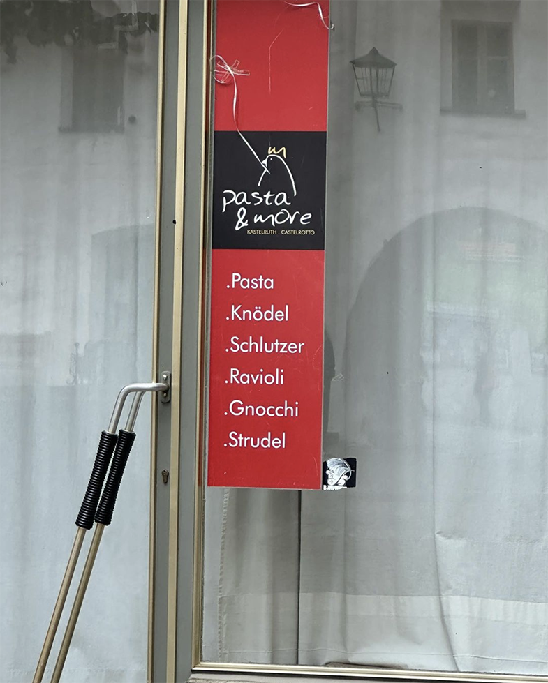 Sign on restaurant door for pasta and more